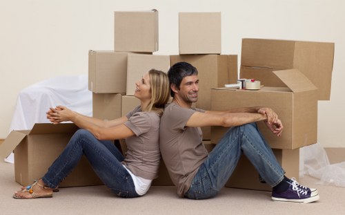 Removal team handling furniture and boxes in a West Kensington flat move