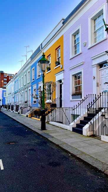 The image depicts a multi-storey residential building with a historic architectural style, featuring red brick walls, white decorative mouldings, and prominent bay windows on each floor. The top floor